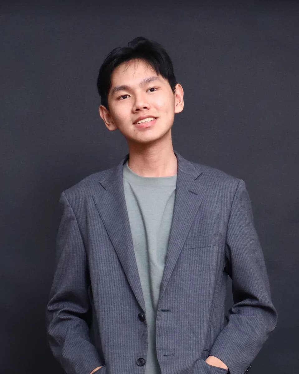 Richard Cen in a grey blazer, smiling